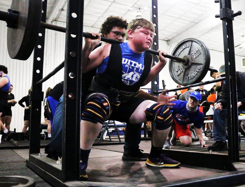 Quitman’s Charlie Matthews works hard on a squat lift at a Quitman meet last Thursday.